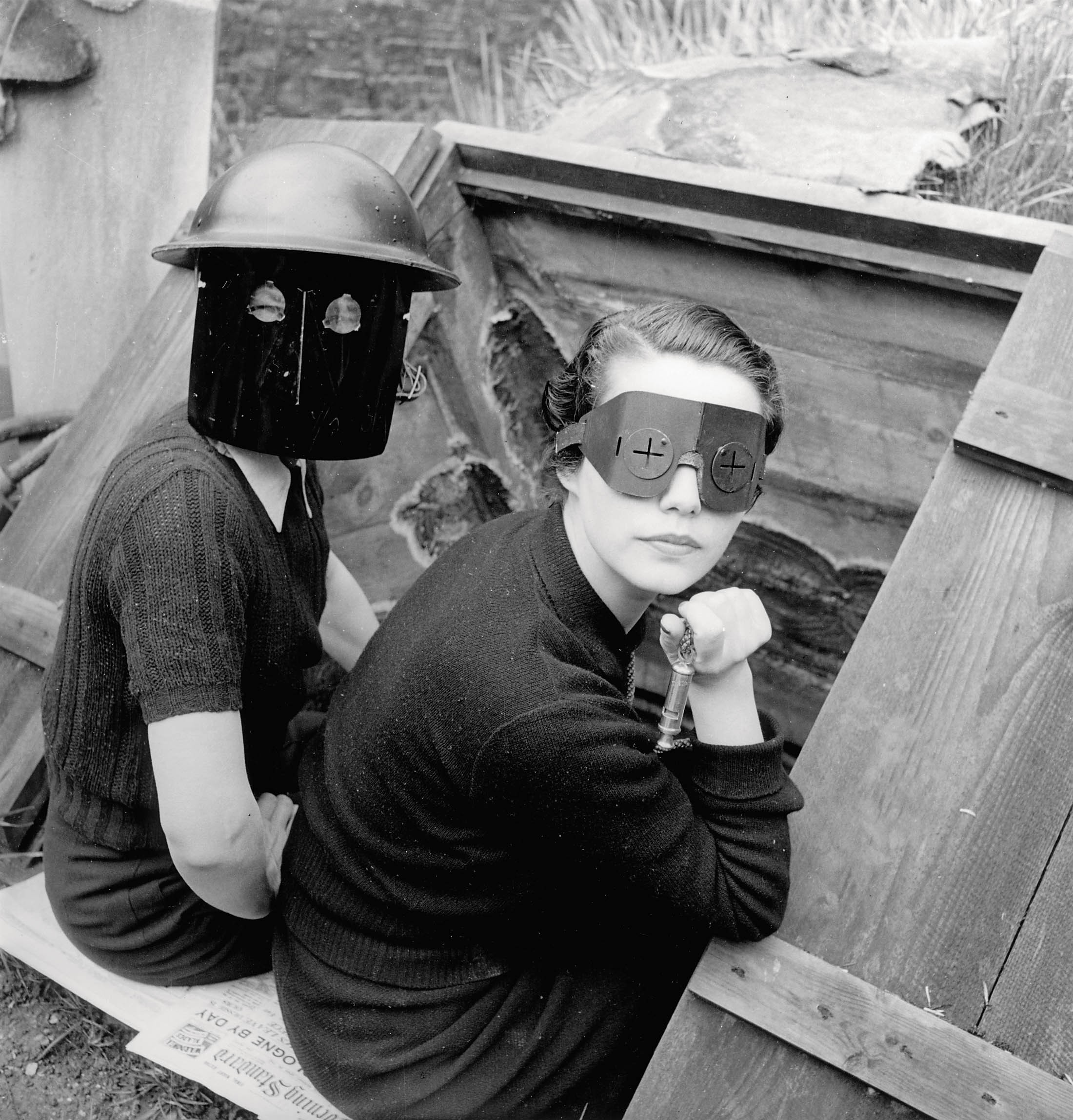 Lee Miller's Fire Masks, 21 Downshire Hill, London, England 1941, showing two women wearing wartime fire masks.